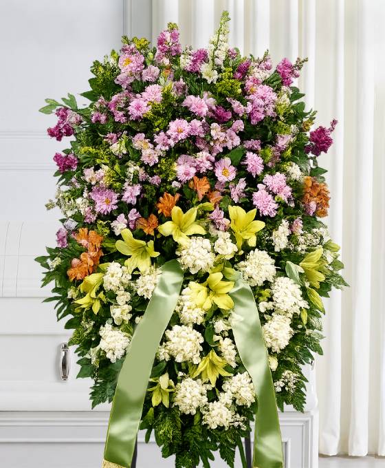 Cuscino funebre di fiori bianchi, gialli, lilla e arancio