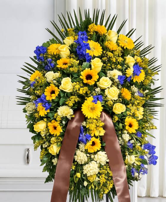 Cuscino funebre di fiori gialli e blu