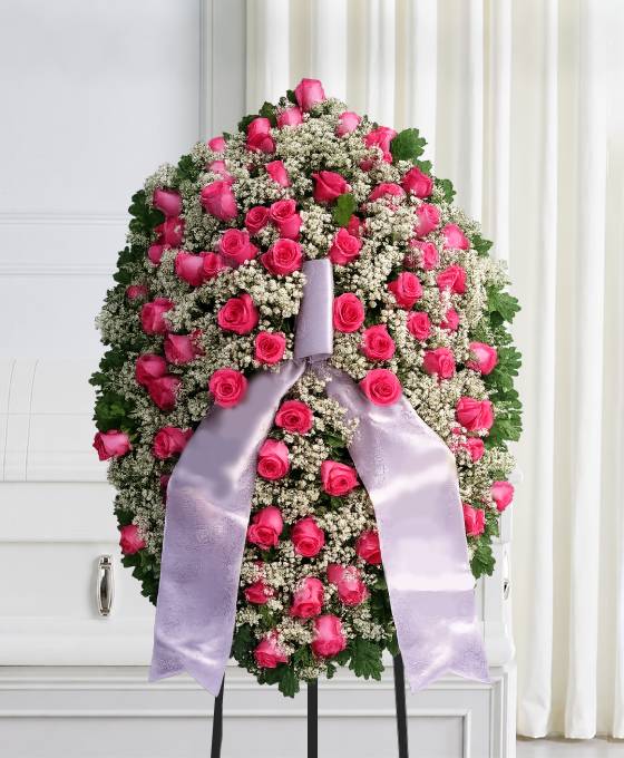 Mezzo cofano funebre di rose fucsia e gisofila